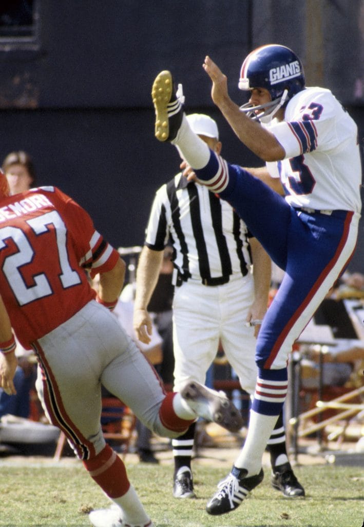 Dave Jennings, one of the best white NFL players, punting for the New York Giants during an NFL game.