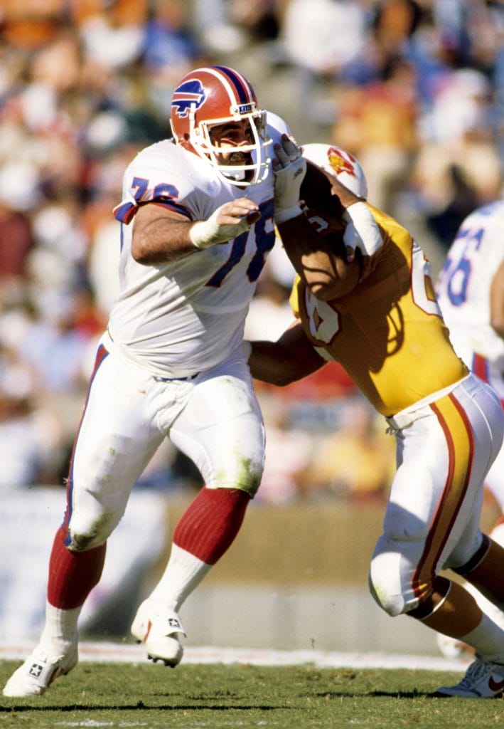 Fred Smerlas of the Buffalo Bills in action, blocking a Buccaneers player while wearing number 76. A legendary figure among the best white NFL nose tackles.