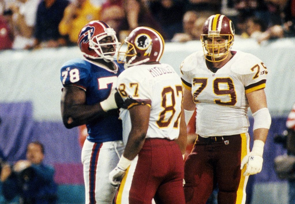 Jim Lachey of the Washington Redskins lining up on the field, recognized as one of the famous white NFL players and dominant offensive tackles.