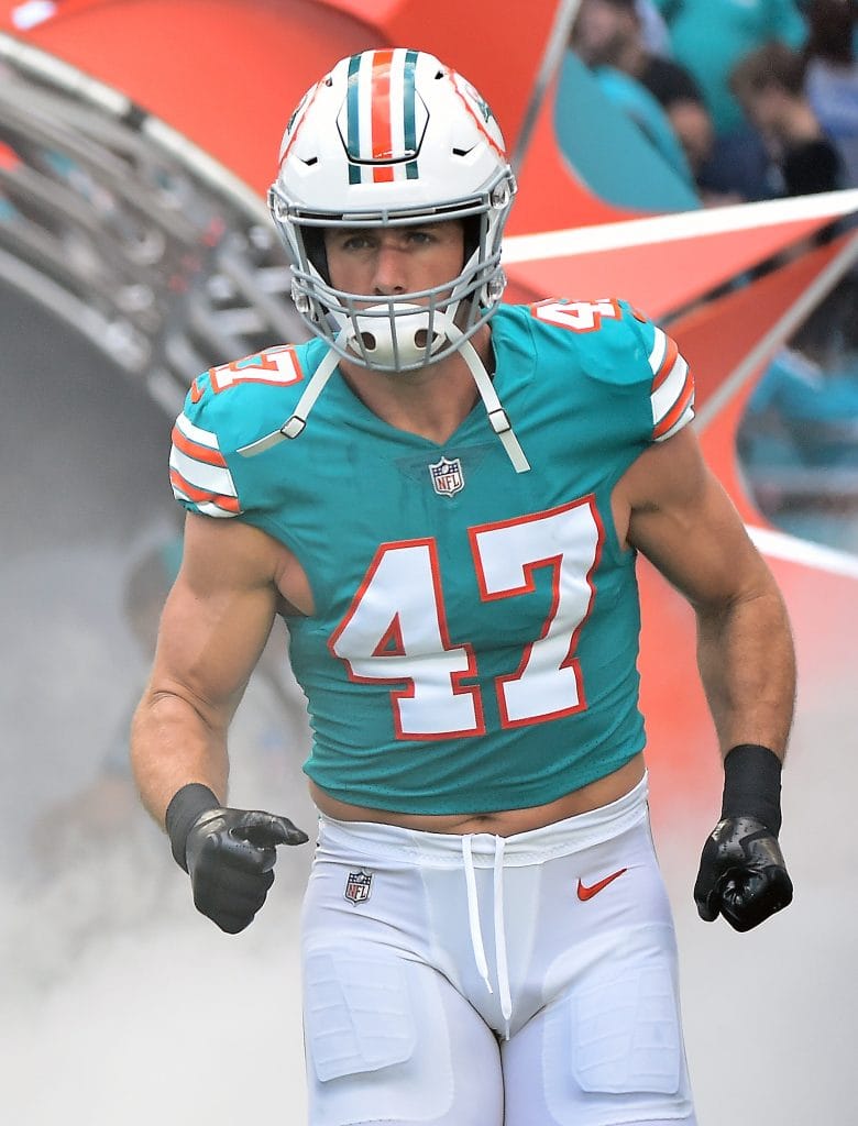 Kiko Alonso, Miami Dolphins linebacker, entering the field with focus and determination, recognized as one of the best white NFL players.