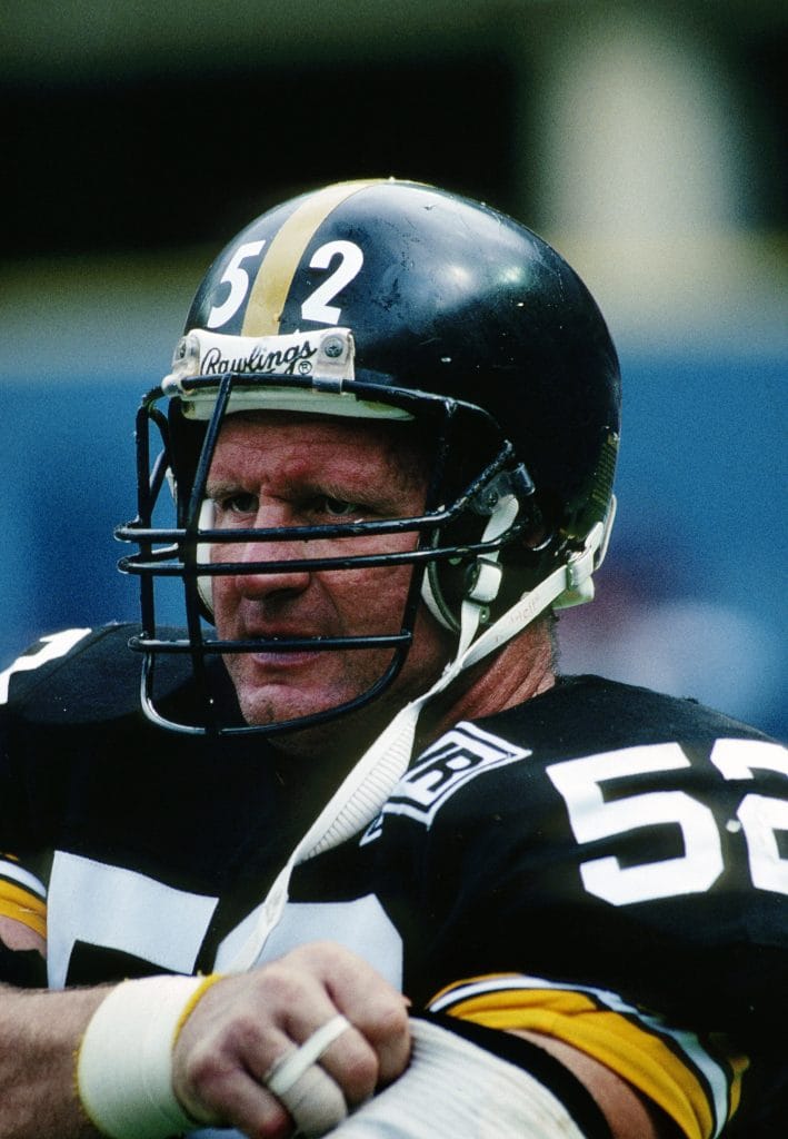 Mike Webster (#52), the heart of the Steelers’ offensive line, epitomizes greatness as one of the best NFL white centers in history.
