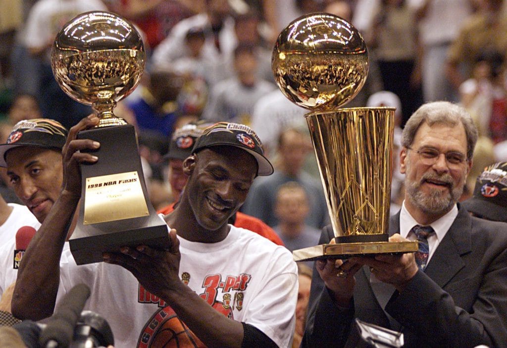  Phil Jackson, the best white coach in NBA history, celebrating another championship victory with Michael Jordan and the Chicago Bulls.