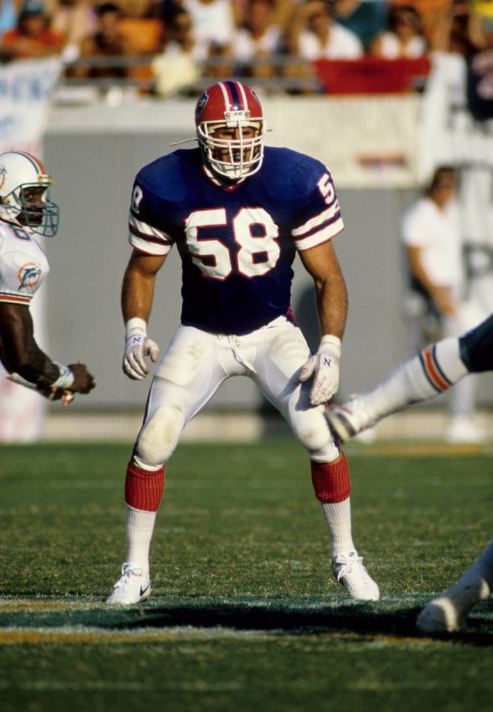 Shane Conlan, in his Buffalo Bills uniform, preparing to defend against the Miami Dolphins, a testament to his ranking among the best white weakside linebackers of all time.