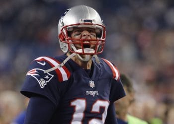 Tom Brady celebrating during a game, showcasing his passion and dominance as one of the Top 10 Quarterbacks Of All Time.