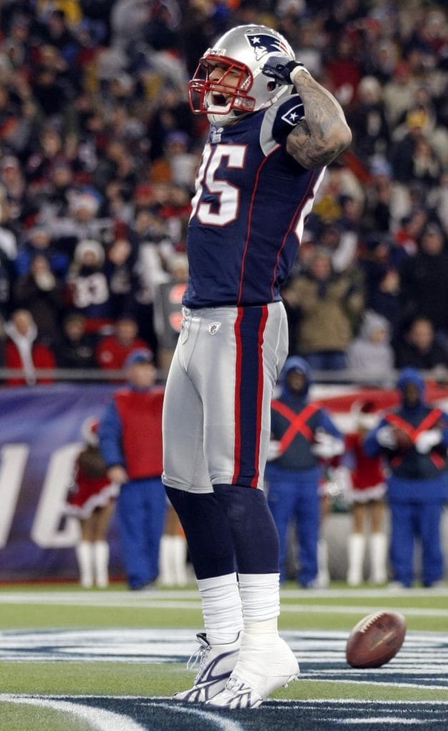 Aaron Hernandez celebrating after a big play, showcasing his skill and versatility as one of the Top 10 Tight Ends Of All Time.