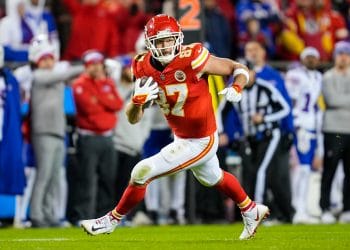 Travis Kelce running after a catch, showcasing his dominance and versatility as one of the Top 10 Tight Ends Of All Time.