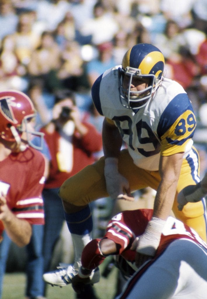 Fred Dryer, one of the top 10 white defensive ends of all time, rushes the quarterback during a game for the Los Angeles Rams.