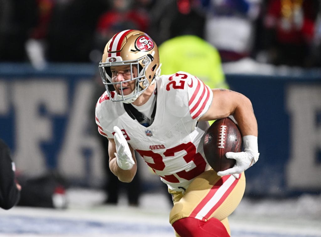 Christian McCaffrey runs the ball during a 49ers game, representing one of the Top 10 White Running Backs of All Time.