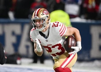Christian McCaffrey runs the ball during a 49ers game, representing one of the Top 10 White Running Backs of All Time.