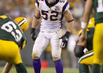 Chad Greenway, Minnesota Vikings linebacker, preparing for a defensive play during an NFL game, representing Top 10 White Weakside Linebackers of All Time.