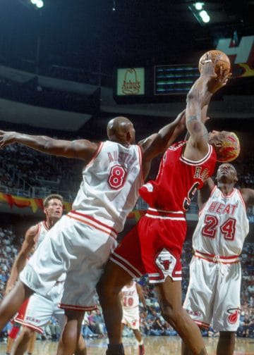 Dennis Rodman outmuscles the Heat for a rebound — a rebounding machine and elite on-ball pest, one of the best NBA defenders ever.