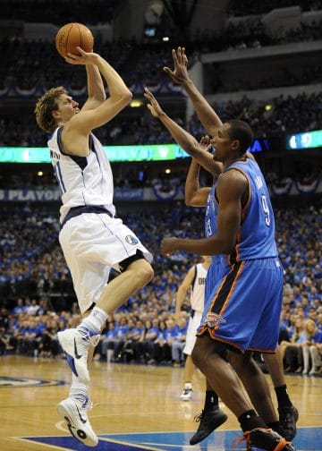 Dirk Nowitzki shooting a fadeaway over Thunder defenders, defining his legacy among the Top 10 Power Forwards of All Time