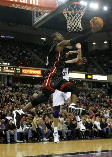 Dwyane Wade of the Miami Heat attempting a layup against the Sacramento Kings