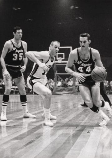 Jerry West dribbling for the Lakers in a vintage black and white photo – top 10 shooting guards of all time