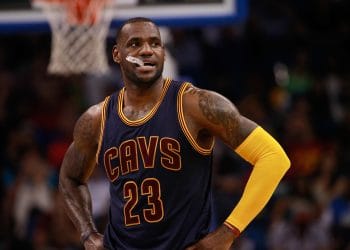 LeBron James standing on the court during a Cavs game, ranked in the Top 10 NBA Players of All Time