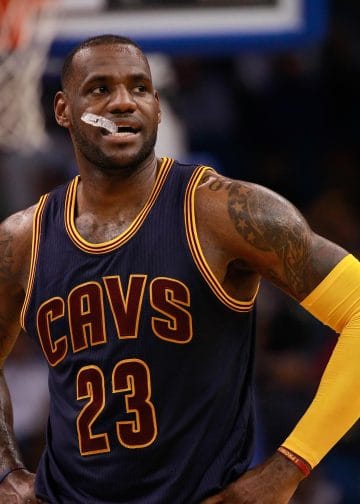 LeBron James standing on the court during a Cavs game, ranked in the Top 10 NBA Players of All Time