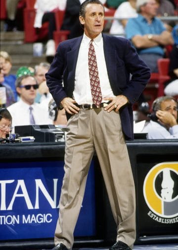 Pat Riley commanding the court — a legendary sideline presence with multiple rings and elite status among NBA coaches.