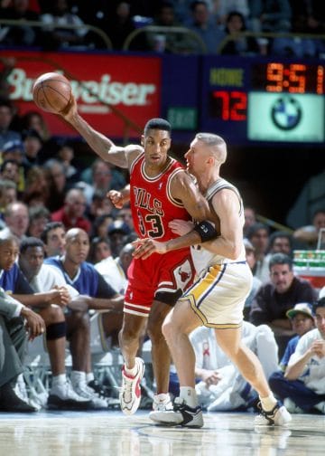 Chicago Bulls forward Scottie Pippen protects the ball while backing down his defender, Chris Mullin.