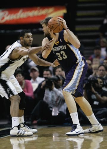  Tim Duncan plays tight post defense against Marc Gasol, showcasing why he's considered one of the Top 10 NBA Defenders of All Time.