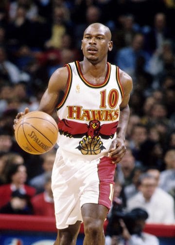Mookie Blaylock dribbling up the court, a defensive anchor and one of the Top 10 Atlanta Hawks of All Time from the 1990s