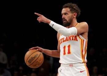 Trae Young directing teammates during a play, one of the Top 10 Atlanta Hawks of All Time and a face of the modern era