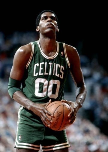 Robert Parish preparing to shoot, a Hall of Fame center and one of the Top 10 Boston Celtics of All Time known for his durability and defense