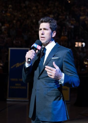 Bob Myers speaking at a Warriors celebration, ranked among the Top 10 NBA GMs of All Time for constructing the Golden State dynasty