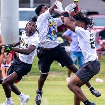 Three players go up for a jump ball during a game featured in the Top 10 7v7 Teams of All Time list
