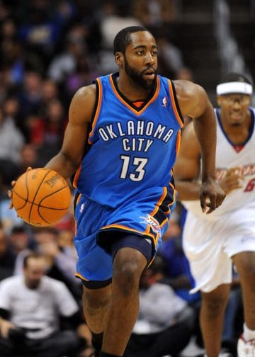 James Harden dribbling the basketball in an Oklahoma City Thunder uniform during an NBA game before he was infamously traded to Houston. 