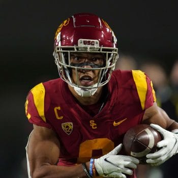 Amon-Ra St. Brown carries the football for USC during a Pac-12 matchup.