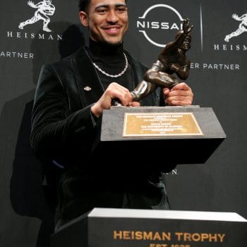  Bryce Young proudly holds his Heisman Trophy, another elite product of the 7v7 football pipeline and the reason why he's 1 on The Top 10 Quarterbacks Who Played 7v7 Football of All Time