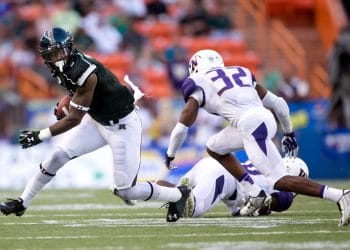 Budda Baker closes in for a tackle against a Hawaii returner during a college football matchup