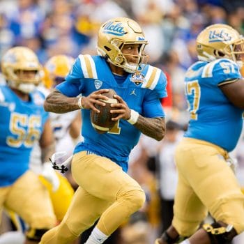 UCLA quarterback Dorian Thompson-Robinson escapes pressure during a bowl game.