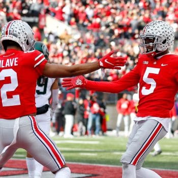 Garrett Wilson and Chris Olave celebrate a touchdown together at Ohio State, both featured in the Top 10 Wide Receivers Who Played 7v7 Football of All Time.