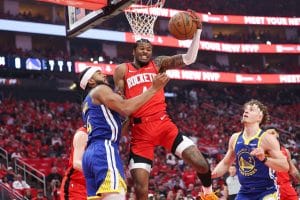 Jalen Green fights through contact against the Golden State Warriors in a home game, struggling to finish at the rim