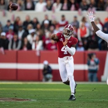 Alabama quarterback Jalen Milroe throws a pass under pressure during the Iron Bowl against Auburn in 2023