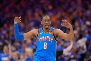 Oklahoma City Thunder forward Jalen Williams celebrates during a home game, raising both arms with intensity