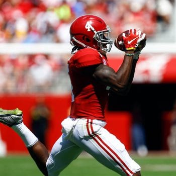 Jerry Jeudy hauls in a deep pass in stride during an Alabama football game.