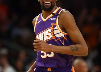 Kevin Durant smiling in a Phoenix Suns jersey during a game, featured in the Kevin Durant Trade analysis