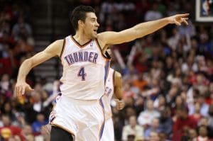 Nick Collison of the Oklahoma City Thunder pointing during an NBA game in a white home jersey.
