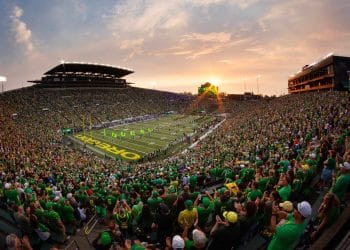 Full crowd at Oregon football stadium during sunset game