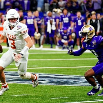 Texas QB Quinn Ewers scrambles away from Washington defender during 2024 College Football Playoff game.