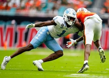 Tony Grimes in action during a game, representing the Top 10 Cornerbacks Who Played 7v7 Football of All Time