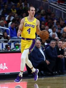 Alex Caruso dribbling the ball in a Lakers uniform during a game, before leaving the team in 2021 free agency.
