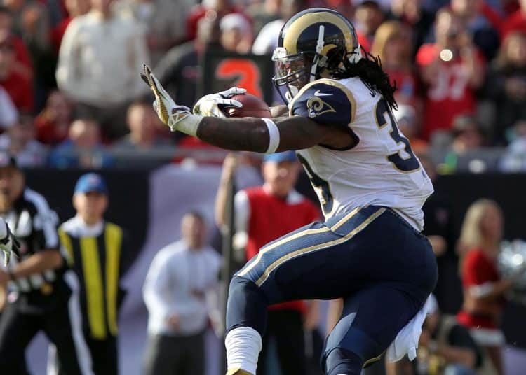 Steven Jackson running the ball for the Rams, showcasing the power and skill of a top player from the 2004 NFL Draft