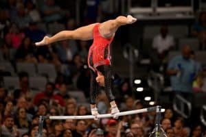 Suni Lee holding a handstand on uneven bars at the Female Artistic Gymnastics Olympics in Paris 2024