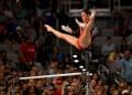 Suni Lee mid-air during her uneven bars release at the Female Artistic Gymnastics Olympics in Paris 2024
